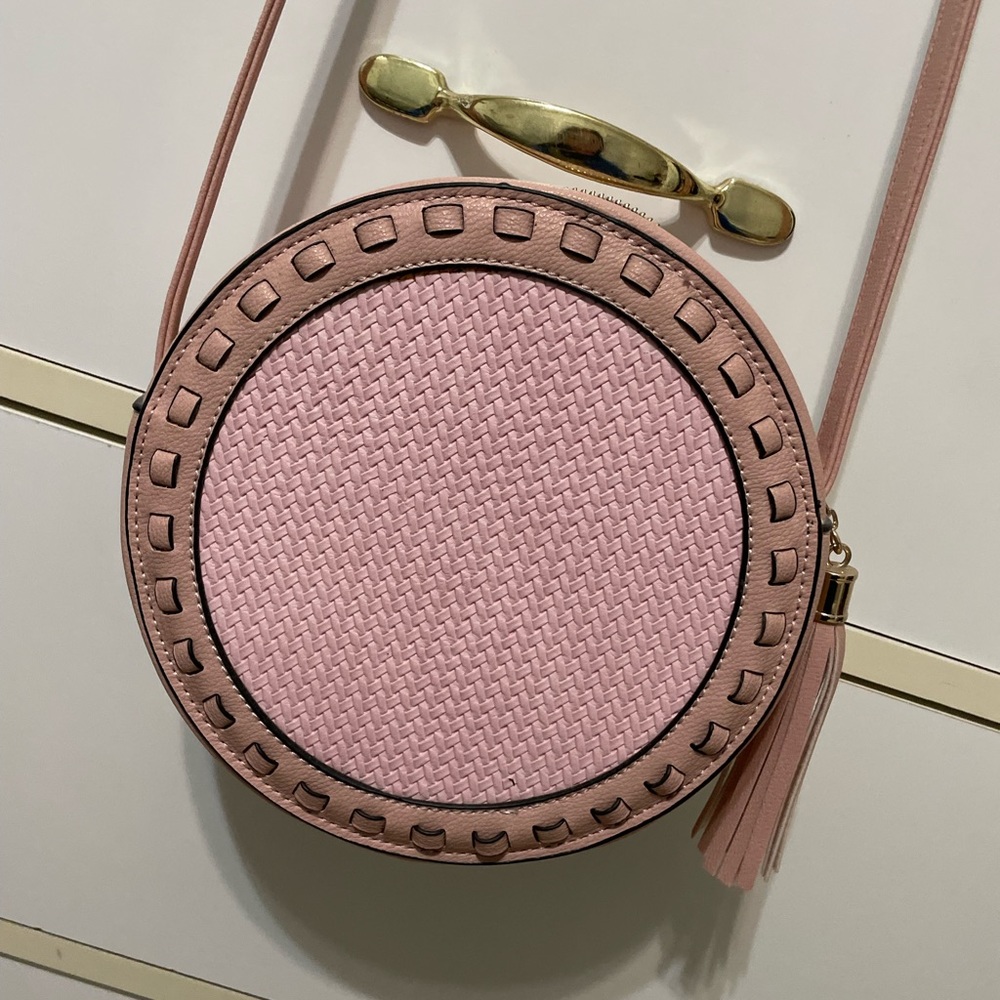 Beautiful pink round crossbody bag fits a nice amount of stuff